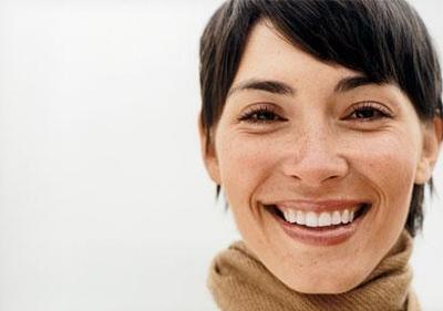 Mujer sonriendo confiada | Dr. Esteban Torres | Cirujano Plástico Santiago: Soluciones estéticas personalizadas.